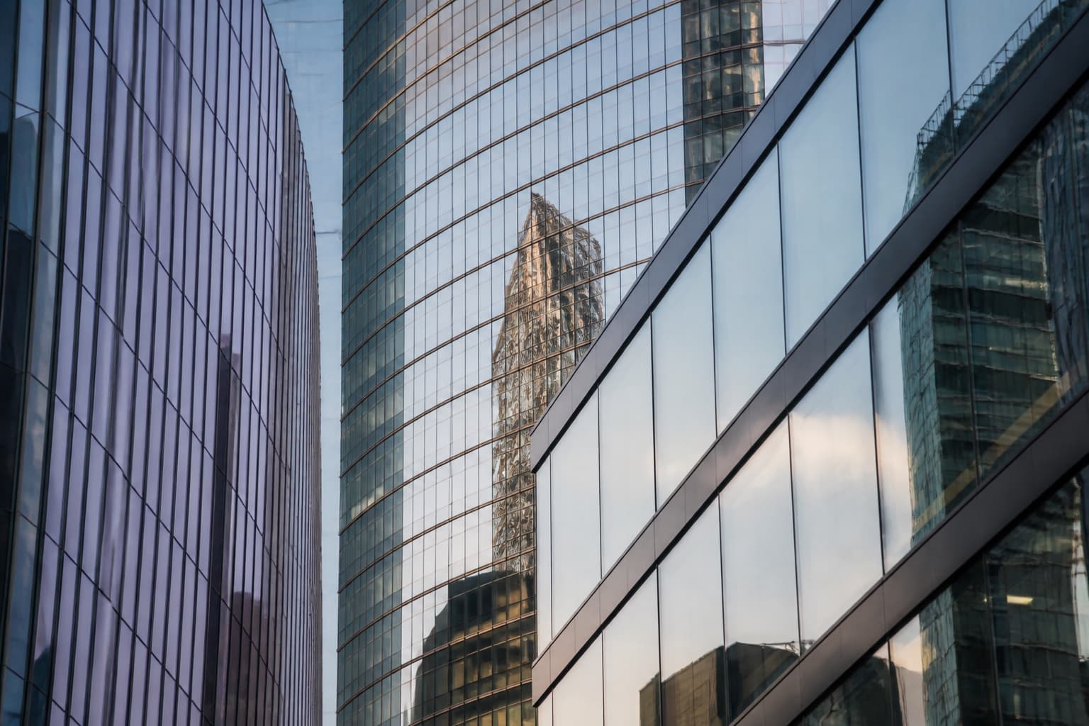 Modern glass architecture reflecting a connected commercial district